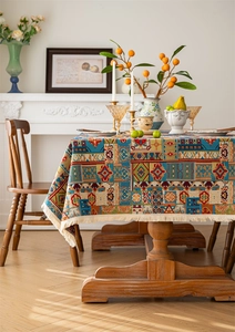 Detail of bohemian jacquard tablecloth featuring colorful geometric floral patterns and tassels