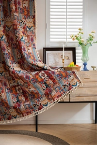 Detailed view of bohemian curtains with geometric patterns and beige decorative tassels