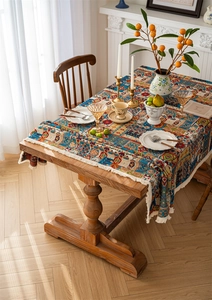 Detail of bohemian jacquard tablecloth with geometric floral patterns and fringe tassels