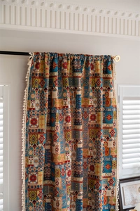 Macro detail of Bohemian geometric jacquard curtain with elegant cream tassel trim