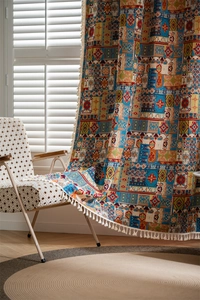 Close-up of Bohemian curtain with colorful geometric patterns and cotton tassels details