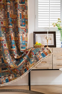 Close-up of Bohemian jacquard curtain with ethnic geometric patterns and white tassels