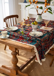 Detail of bohemian jacquard tablecloth with geometric floral patterns and white fringe edge