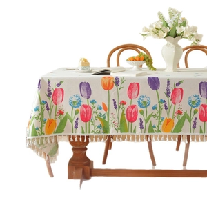 Floral tulip print tablecloth with tassels on beige cotton blend fabric for dining decor