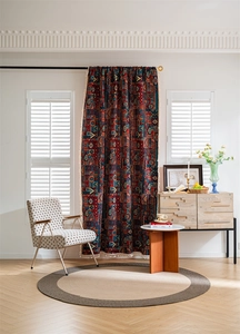 Detail of boho semi-blackout curtain with tribal pattern and fringe trimming for home
