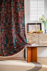 Detail showing Bohemian geometric pattern and white handmade tassels on cotton-blend curtain