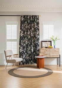Detailed close-up of Bohemian black and white floral curtain with decorative white tassels