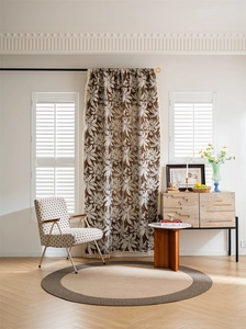 Detailed view of Boho style curtain with brown leaf pattern and decorative fringe