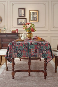 Detail of bohemian jacquard tablecloth with geometric floral patterns on a wooden table