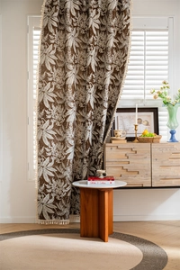 Detailed texture of bohemian palm leaf print curtain with elegant white tassels