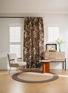 Detailed view of dark brown floral jacquard curtain with white tassels in cottagecore style