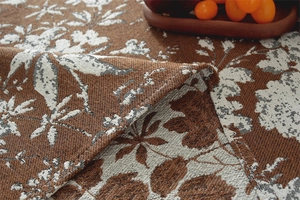 Macro shot of retro bohemian jacquard tablecloth with intricate floral pattern and stitching