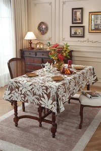 Detailed macro view of retro brown table runner with white tropical palm leaf patterns