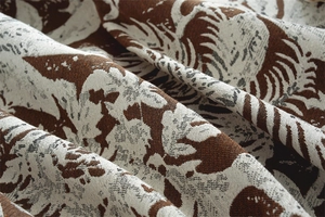Macro detail of Bohemian jacquard tablecloth with intricate brown floral weave patterns