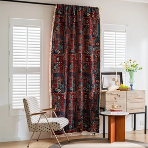 Bohemian geometric curtains with tassels, hanging in a cozy living room with soft light