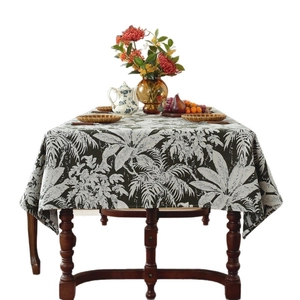 Retro Bohemian tablecloth with white tropical palm leaf patterns on a dark background