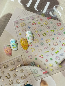 Detail of 3D gold butterfly nail stickers with cute cherry and star patterns