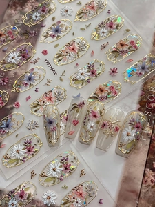 Macro shot of vintage gold embossed floral nail stickers with intricate flower designs