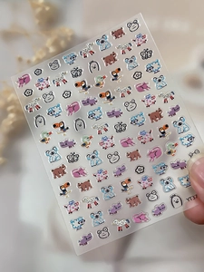 Detailed view of embossed cartoon animal nail stickers featuring koalas, bears and frogs