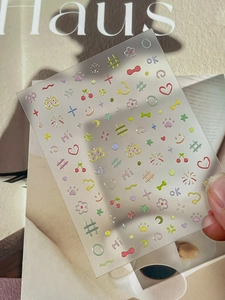 Detail of colorful butterfly and heart nail art stickers on transparent backing