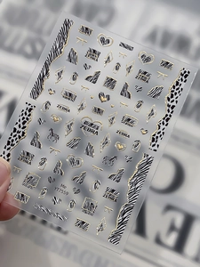 Macro view of YT7559 gold bronzing zebra pattern nail art stickers with 3D embossed heart