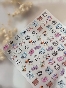 Close-up of embossed cartoon animal nail stickers with holographic glitter and laser texture