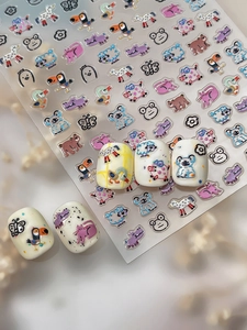 Detail of 3D embossed cartoon animal nail art stickers featuring cute koalas and pigs