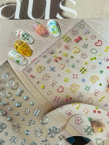 Detail of colorful butterfly and silver embossed nail art stickers on display tips