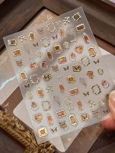 Macro view of vintage gold-embossed nail stickers with marble texture and frames