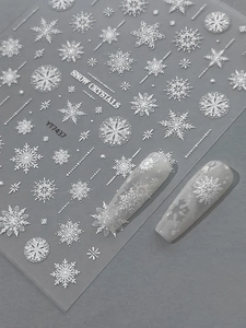 Macro view of embossed snowflake nail stickers showing 3D texture on nails