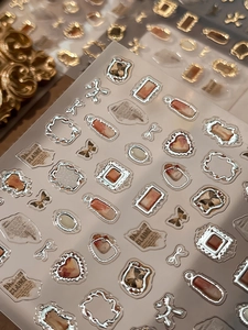 Macro shot of 3D metallic frame and vintage butterfly gold foil nail art stickers