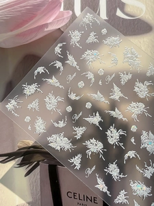 Detailed view of 5D embossed white rose and butterfly nail art stickers with aurora finish