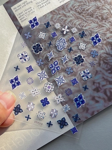Detailed macro of blue Bohemian embossed nail stickers with intricate floral mandala patterns