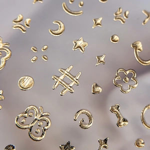 3D gold embossed nail stickers with stars, butterflies and floral patterns decoration