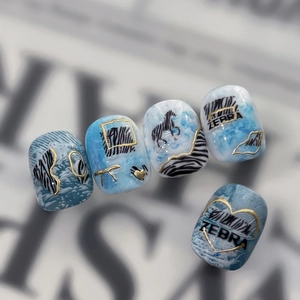 Y2K vintage blue zebra print press-on nails with gold heart accents and zebra lettering