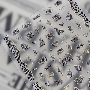 Gold-foiled zebra and leopard print nail stickers with heart and butterfly motifs