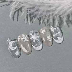 Winter snowflake embossed press-on nails with silver glitter and feather textures