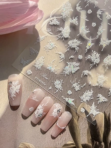 Detailed 3D white rose and butterfly nail art stickers applied on pink gradient nails