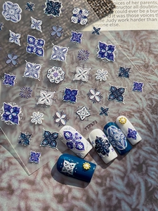 Close-up of 5D embossed blue and white floral nail stickers with high relief texture