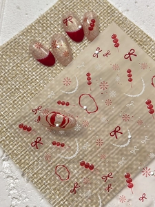 Detailed 5D embossed nail stickers featuring red bows, berries and white snowflakes