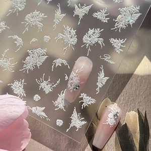 5D embossed nail stickers featuring white floral and butterfly designs on gradient nails