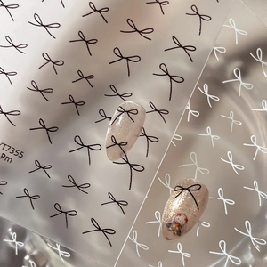Minimalist black and white bow nail stickers featuring thin lines on a transparent base