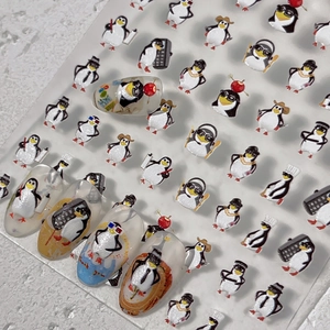 Autocollants d'ongles mignons motifs manchots variés sur une planche professionnelle