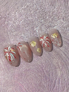 Macro detail of press-on nails featuring golden New Year fireworks and Fu character