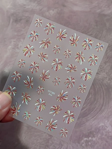 Detailed macro view of colorful laser fireworks nail art stickers with glitter finish