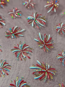 Macro detail of 3D laser firework nail stickers with holographic red and gold glitter