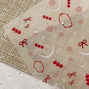 Winter festive nail stickers featuring red bows, sugar gourds, and white snowflakes
