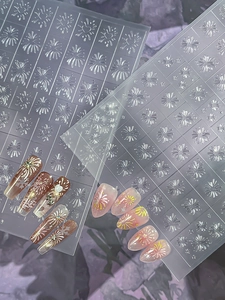 Macro detail of silver snowflake and firework nail art stickers with 3D embossed texture