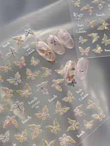 Macro view of 3D iridescent butterfly nail stickers with pearlescent shell finish