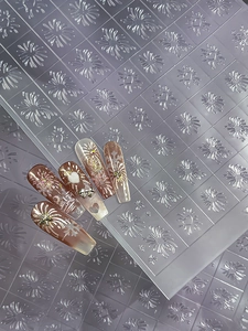 Detail of 3D embossed nail stickers featuring elegant fireworks and heart patterns